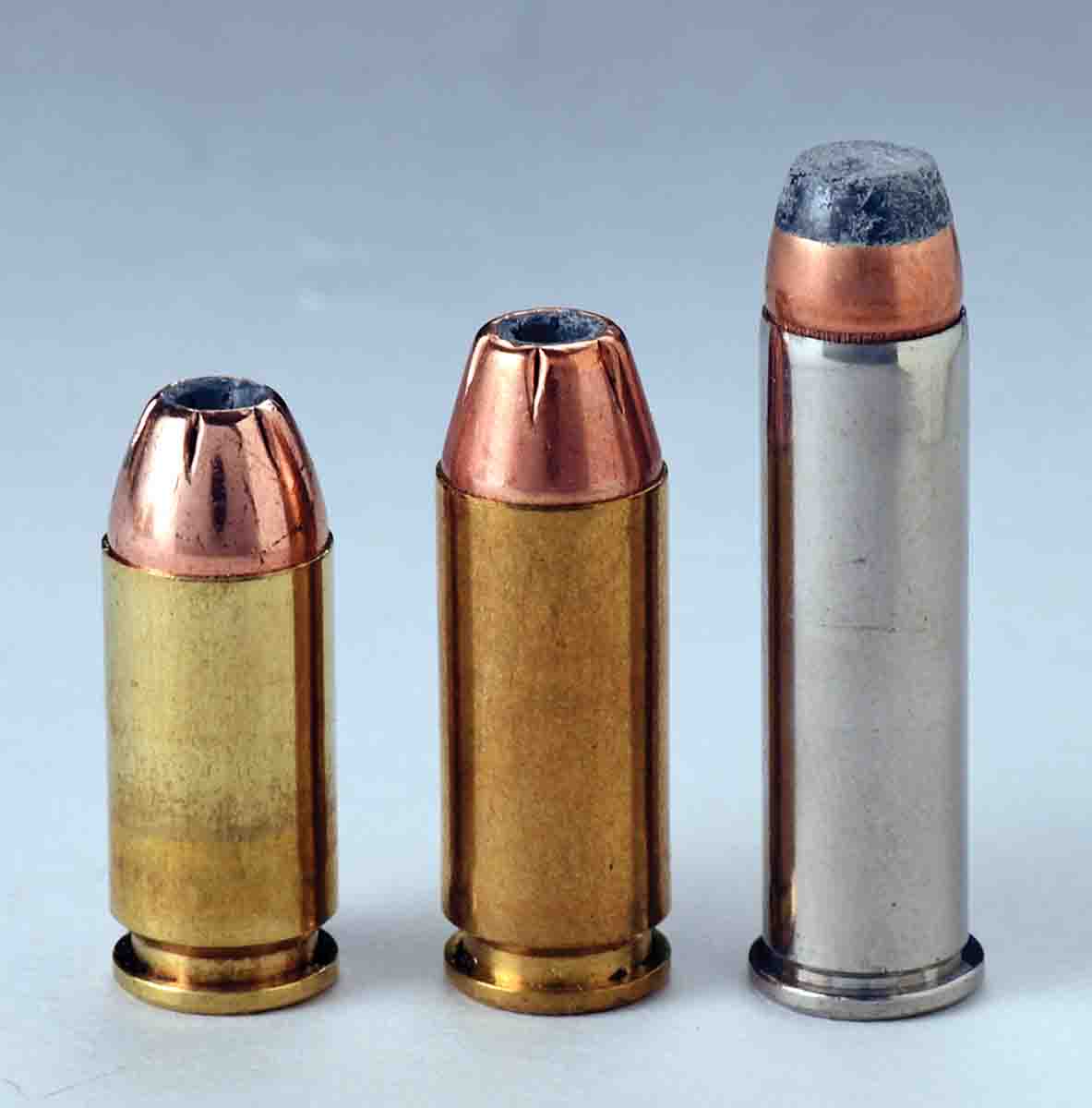 These cartridges include (left to right): a .40 S&W round with no crimp, a 10mm Auto with a light taper crimp  and a .357 Magnum revolver round with a pronounced roll crimp. The .40 and 10mm need a positive case mouth edge exposed for proper headspacing while the rimmed revolver round does not.